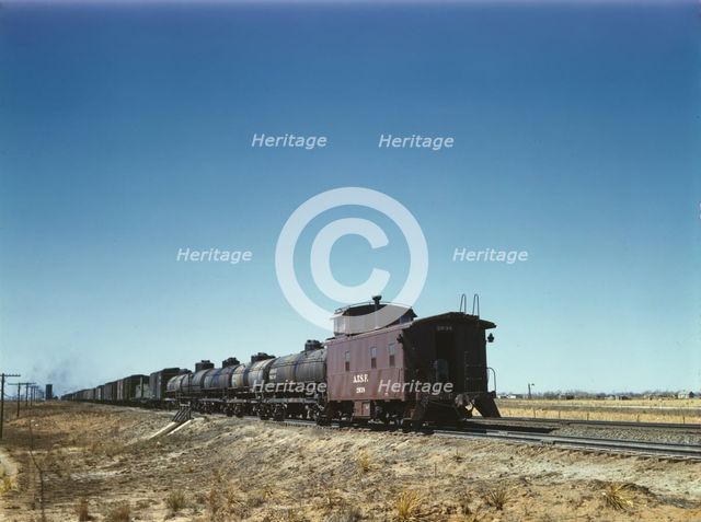 Santa Fe R.R. west bound freight stopping for water, Melrose, New Mexico, 1943. Creator: Jack Delano.
