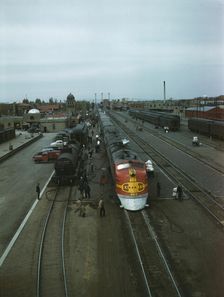 Santa Fe R.R. streamliner, the "super Chief," being serviced..., Albuquerque, N.Mexico , 1943. Creator: Jack Delano