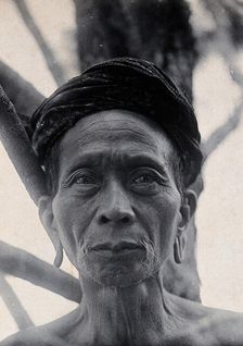 Sarawak: Tama Kulieng, a chief of the Butang Kayan River tribe, c1900.. Creator: Unknown