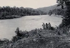 Sarawak: three men standing by the Baram River, c1900. Creator: Unknown