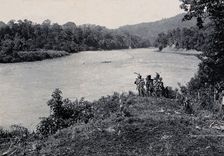 Sarawak: three men standing by the Baram River, c1900. Creator: Unknown