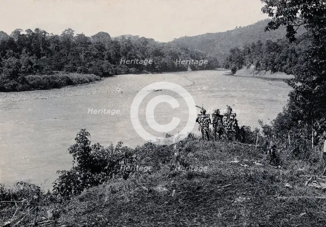 Sarawak: three men standing by the Baram River, c1900. Creator: Unknown.