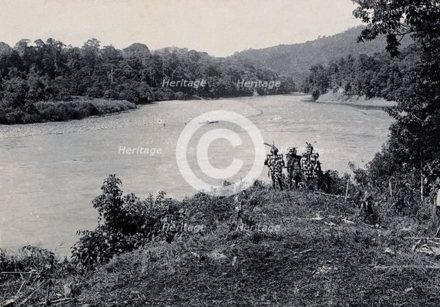 Sarawak: three men standing by the Baram River, c1900. Creator: Unknown.