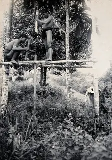 Sarawak: two Kenyah people boring a blowpipe, c1900. Creator: Unknown