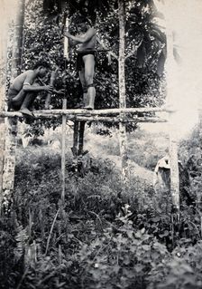 Sarawak: two Kenyah people boring a blowpipe, c1900. Creator: Unknown