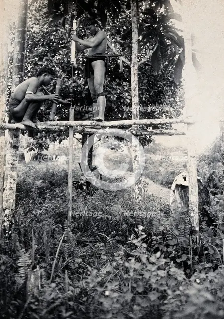 Sarawak: two Kenyah people boring a blowpipe, c1900. Creator: Unknown.