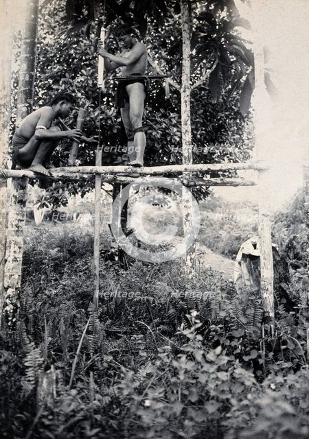 Sarawak: two Kenyah people boring a blowpipe, c1900. Creator: Unknown.