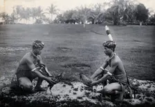 Sarawak: two Sea Dayaks at a cockfight, c1900. Creator: Unknown