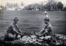 Sarawak: two Sea Dayaks at a cockfight, c1900. Creator: Unknown