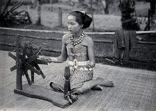 Sarawak: a girl spinning cotton into thread, c1900. Creator: Unknown