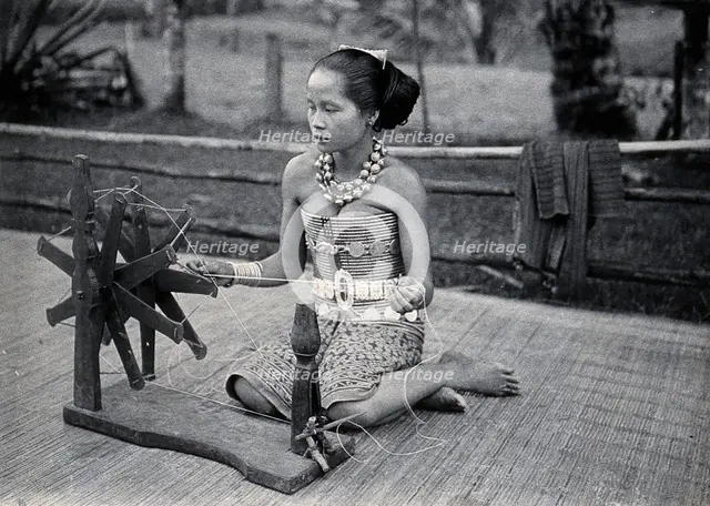 Sarawak: a girl spinning cotton into thread, c1900. Creator: Unknown.