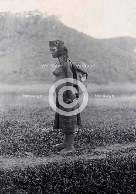 Sarawak: a Kayan woman carrying her child in a sling, c19th century. Creator: Unknown.