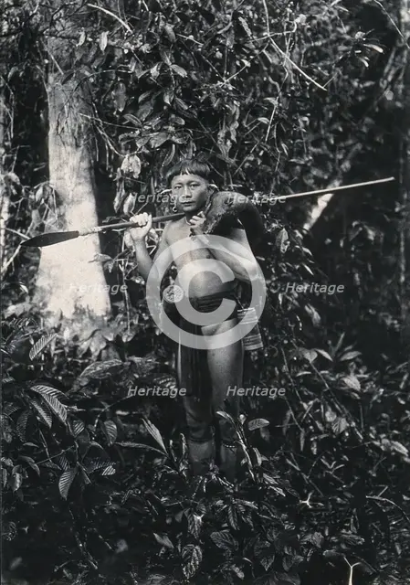 Sarawak: a Kenyah hunter with blowpipe and dead animal, c1900. Creator: Unknown.
