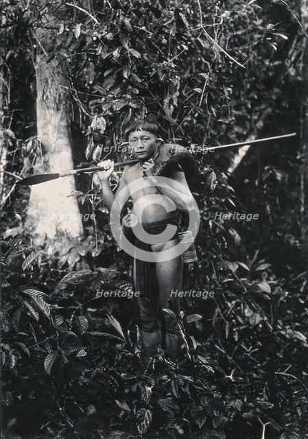 Sarawak: a Kenyah hunter with blowpipe and dead animal, c1900. Creator: Unknown.