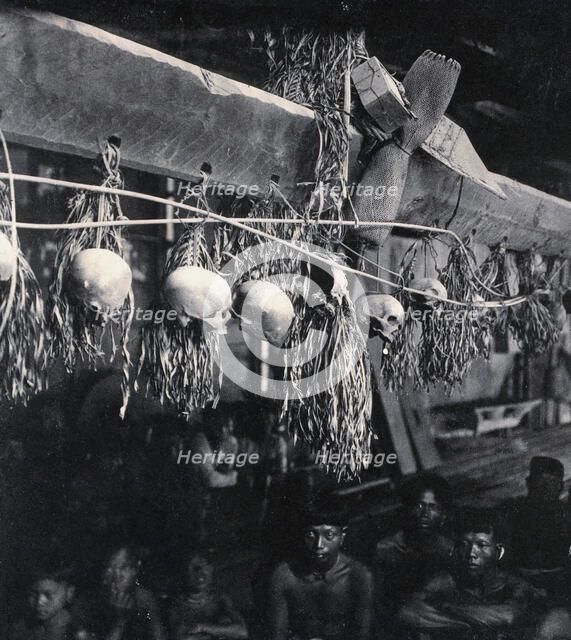 Sarawak: decorated human skulls hanging in a Kayan house, c1900. Creator: Unknown.