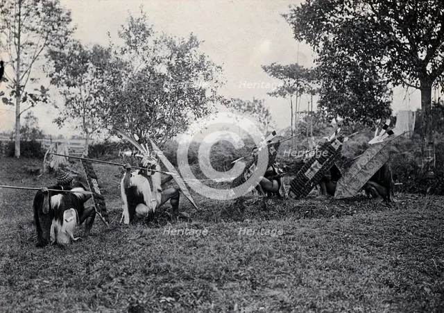 Sarawak: five Kenyah warriors in a warfare ritual, c1900. Creator: Unknown.