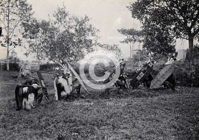 Sarawak: five Kenyah warriors in a warfare ritual, c1900. Creator: Unknown.