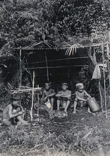 Sarawak: four Kayan hunters in their camp, c1900. Creator: Unknown