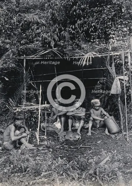 Sarawak: four Kayan hunters in their camp, c1900. Creator: Unknown.