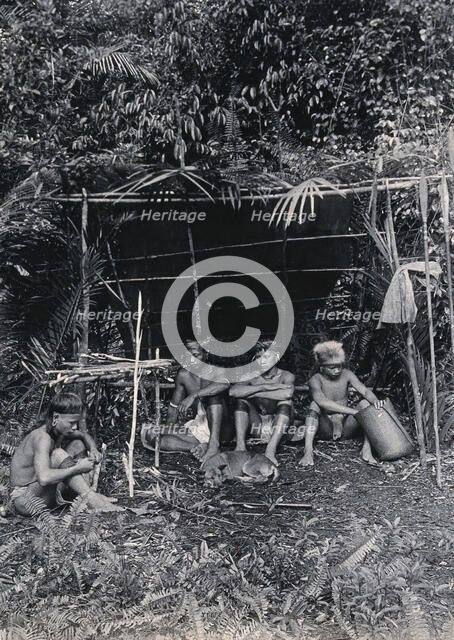 Sarawak: four Kayan hunters in their camp, c1900. Creator: Unknown.