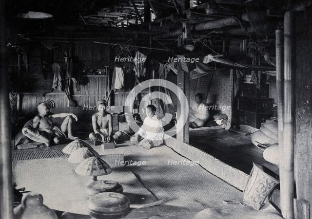 Sarawak: interior of a Kadayan tribal house, with a meal laid out, c1900. Creator: Unknown.