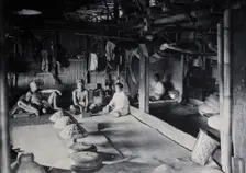 Sarawak: interior of a Kadayan tribal house, with a meal laid out, c1900. Creator: Unknown