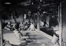Sarawak: interior of a Kadayan tribal house, with a meal laid out, c1900. Creator: Unknown