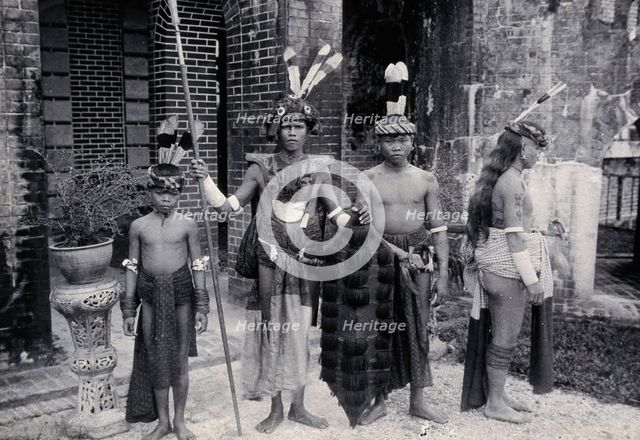 Sarawak: Sea Dayaks with weapons and head-dresses, c1900. Creator: Unknown.