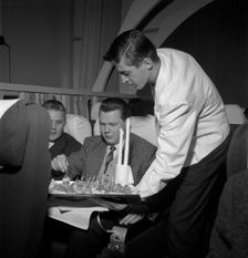 SAS steward serving snacks on a flight, 1960. Creator: Torkel Lindeberg