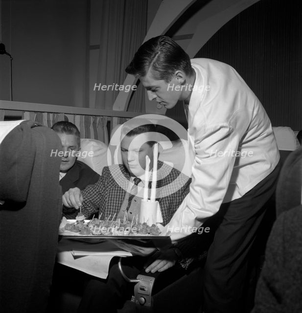SAS steward serving snacks on a flight, 1960. Creator: Torkel Lindeberg.