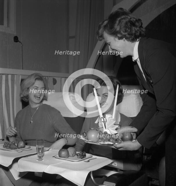 SAS stewardess serving on a flight, 1960. Artist: Torkel Lindeberg