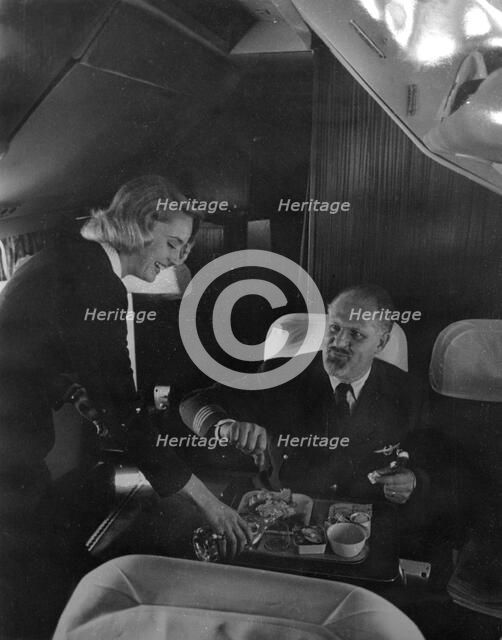 SAS stewardess serving on a flight, 1960. Artist: Torkel Lindeberg