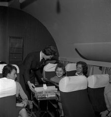 SAS stewardess serving on a flight, 1960. Creator: Torkel Lindeberg
