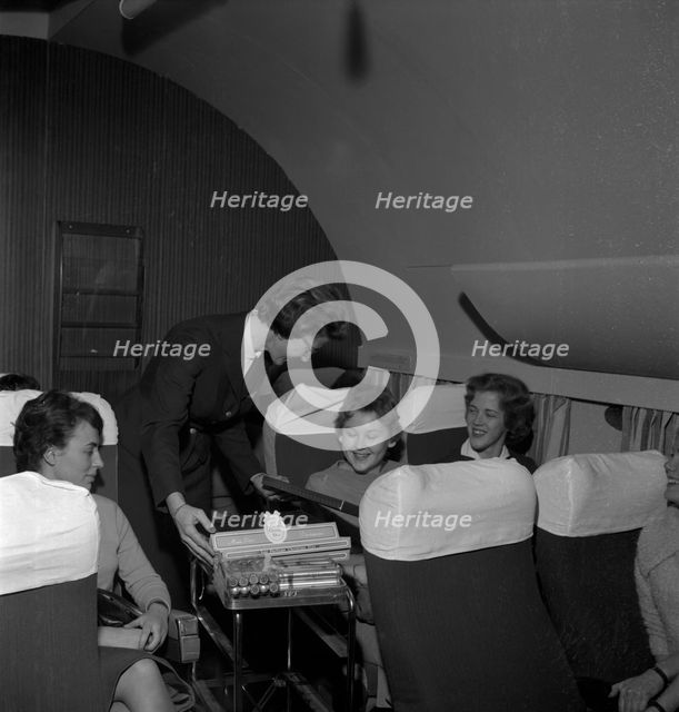 SAS stewardess serving on a flight, 1960. Creator: Torkel Lindeberg.