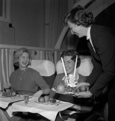 SAS stewardess serving on a flight, 1960. Creator: Torkel Lindeberg