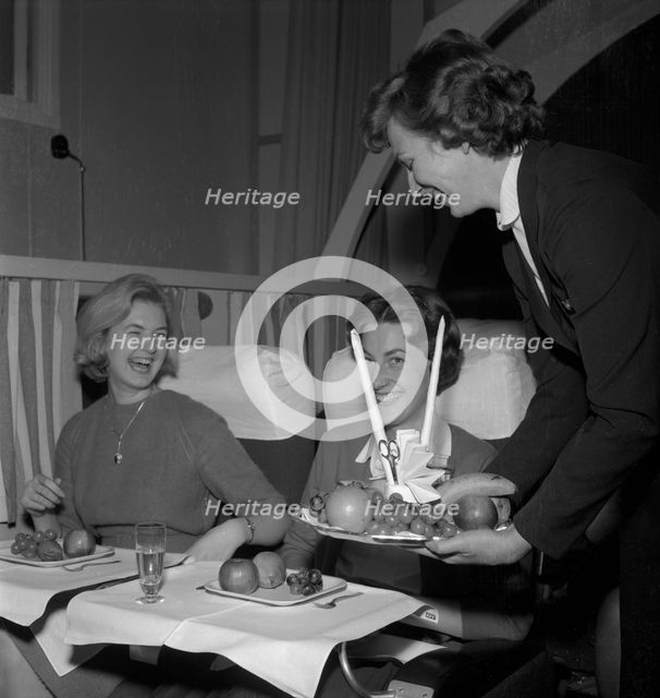 SAS stewardess serving on a flight, 1960. Creator: Torkel Lindeberg.
