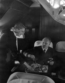 SAS stewardess serving on a flight, 1960. Creator: Torkel Lindeberg