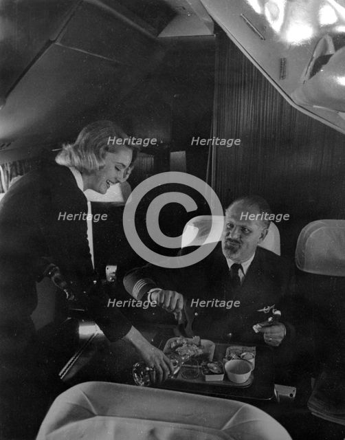 SAS stewardess serving on a flight, 1960. Creator: Torkel Lindeberg.