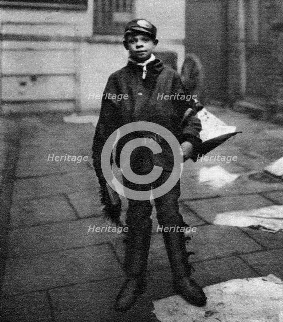 'Scavenger boy', who cleans up horse droppings in the road, London, 1926-1927. Artist: Unknown