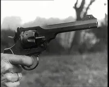Scene from the Feature Film The White Sheik A Pistol Being Held By a Man With His Finger...,1920s Creator: British Pathe Ltd