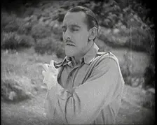 Scene from the Feature Film The White Sheik An Actor Portraying a Male Soldier Grabbing..., 1920s Creator: British Pathe Ltd