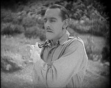 Scene from the Feature Film The White Sheik An Actor Portraying a Male Soldier Grabbing..., 1920s Creator: British Pathe Ltd