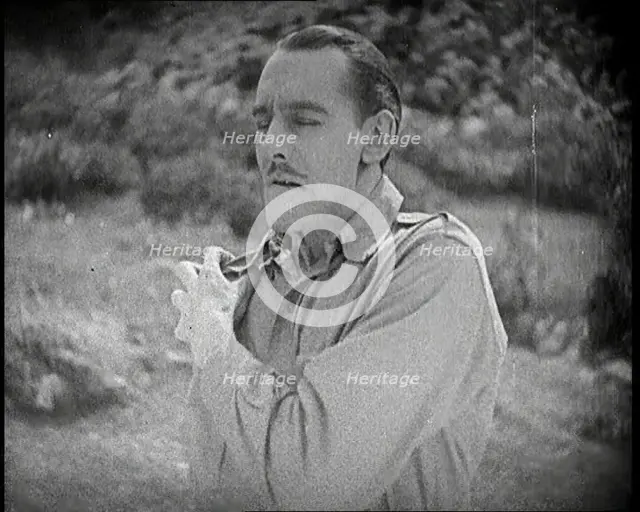 Scene from the Feature Film 'The White Sheik'. An Actor Portraying a Male Soldier Grabbing..., 1920s Creator: British Pathe Ltd.