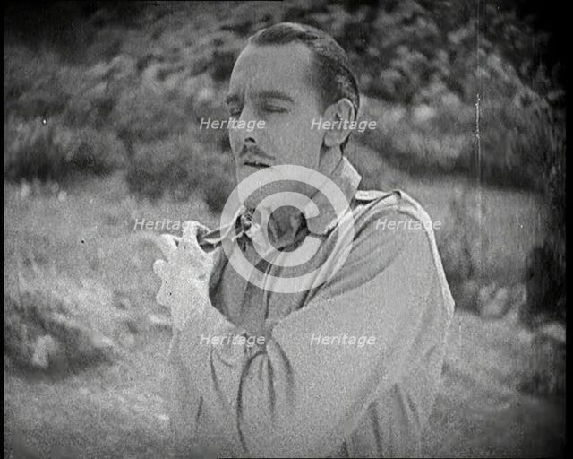 Scene from the Feature Film 'The White Sheik'. An Actor Portraying a Male Soldier Grabbing..., 1920s Creator: British Pathe Ltd.