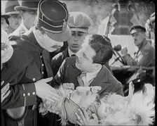 Scene from the Film The Compulsory Husband': Monty Banks Holding a Dog That He Has Run Over, 1920s. Creator: British Pathe Ltd
