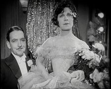 Scene from the Film The Compulsory Husband': a Female Actor Sitting on a Male Actors Lap, 1920s. Creator: British Pathe Ltd