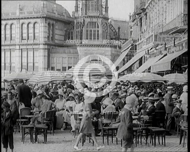 Scene from the Film 'The Compulsory Husband':  Crowds of Holiday Makers Sitting at Out..., 1920s. Creator: British Pathe Ltd.