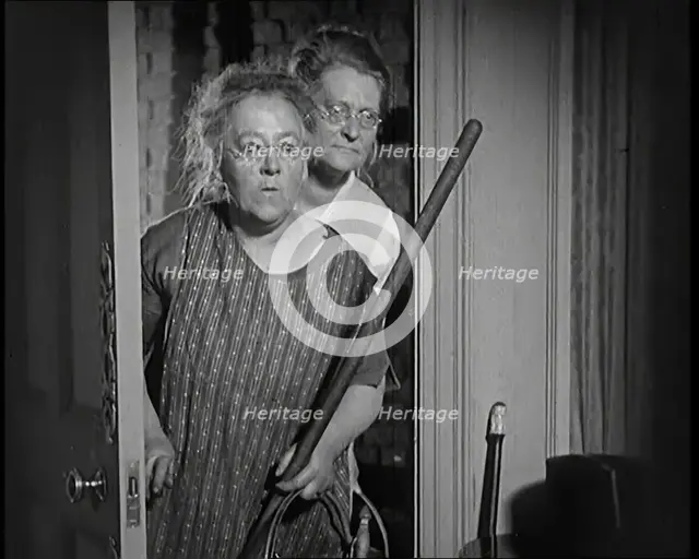 Scene from the Film 'The Compulsory Husband': Two Actors Portraying Cleaners Carrying..., 1920s. Creator: British Pathe Ltd.