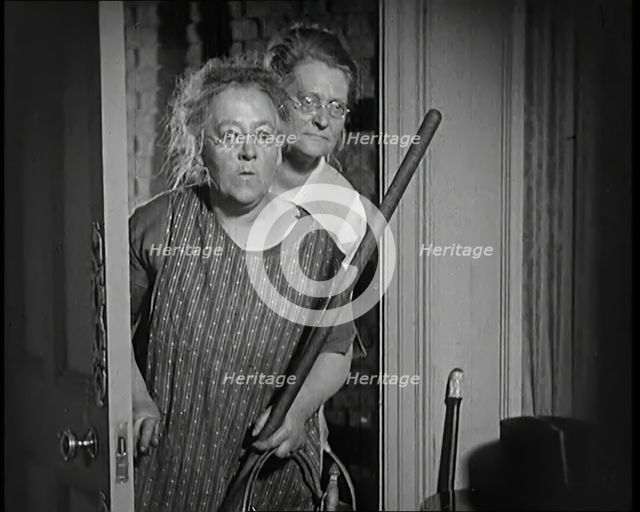 Scene from the Film 'The Compulsory Husband': Two Actors Portraying Cleaners Carrying..., 1920s. Creator: British Pathe Ltd.