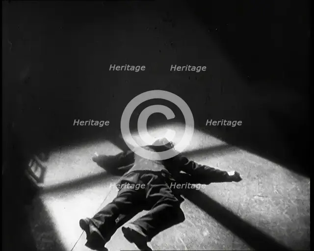 Scene from the Film 'The Informer':  Lars Hansen Falling Down Dead in a Church After..., 1920s. Creator: British Pathe Ltd.